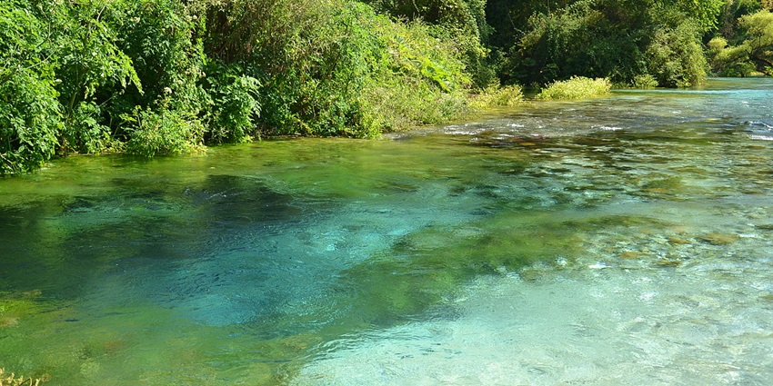 Marvel at the Blue Eye's mesmerising spring, a natural wonder with vibrant blue waters and lush surroundings.