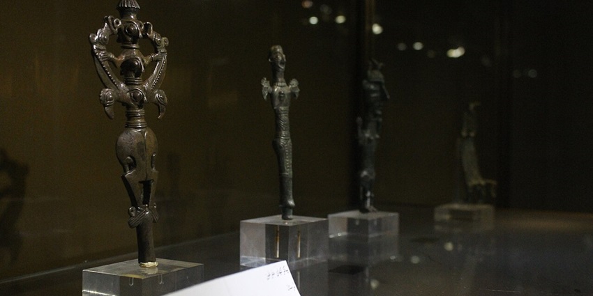 Reza Abbasi Museum with multiple black antiques inside a glass box and small white signage