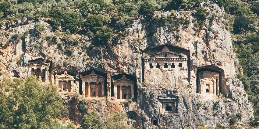 Ancient Lycian rock tombs carved into cliffs, highlighting the historical depth of Monuments in Turkey.
