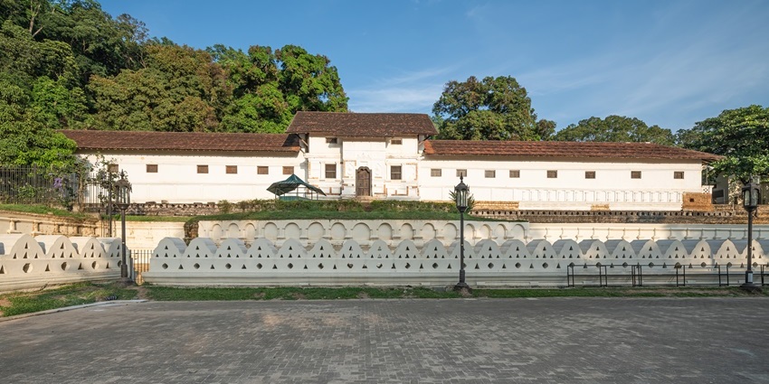 The Royal Palace of Kandy, surrounded by greenery and pathways, is one of the Historical Places in Kandy
