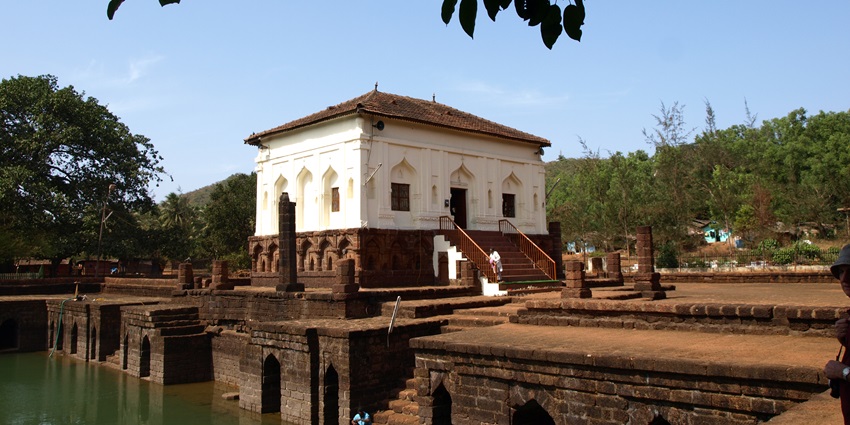 Safa masjid with unique Islamic architecture, a man standing on the stairs and greenery