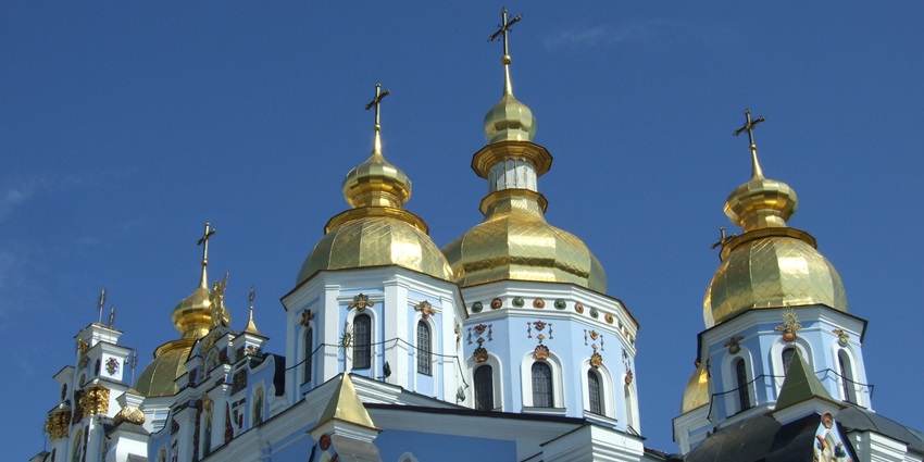 Saint Sophia Cathedral with golden dorm shining brightly under clear sky, one of the best historical places in Ukraine.