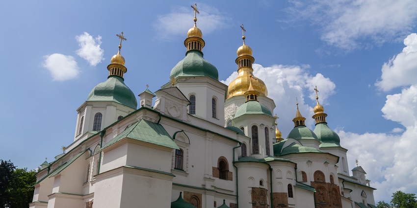 Saint Sophia’s Cathedral in Kyiv with golden domes shining under clear blue skies.