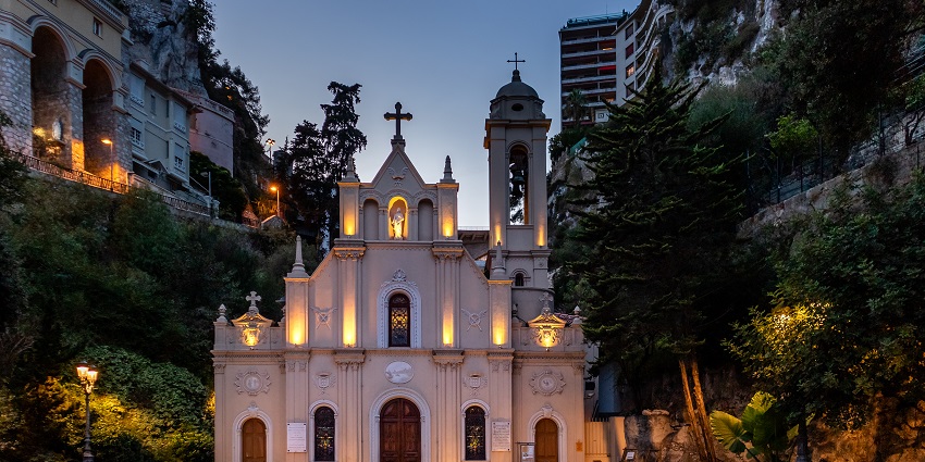 Sainte-Dévote Chapel in the evening with detailed architecture and a statue of Christ