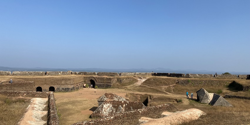 Hilltop view of Manjarabad Fort with star-shaped walls and surrounding greenery.