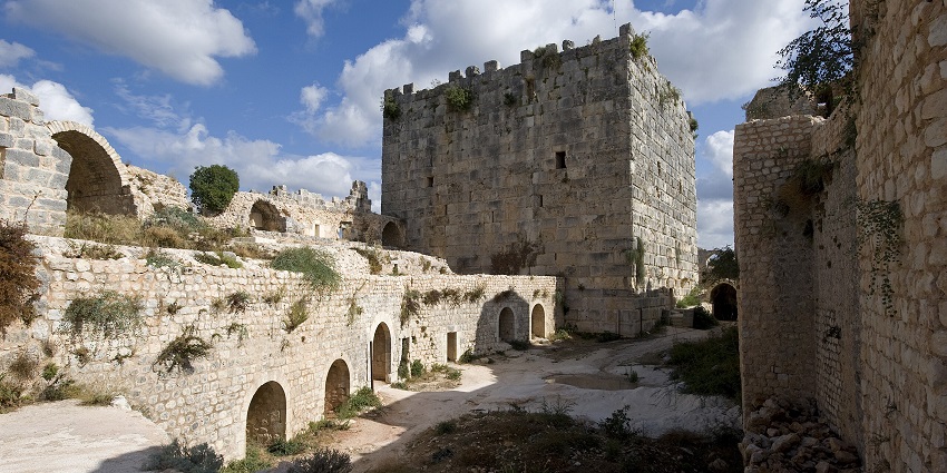 Qalaat Salah El-Din with old ruined architecture, grass growing on the terraces and on the walls