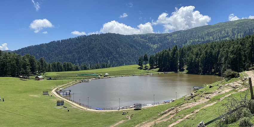 Scenic Sanasar Lake with pine forests and green fields among places to visit in Jammu in May