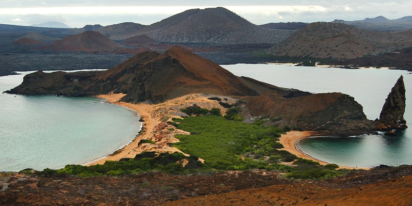 Panoramic view of the Santiago Island, with sunlight shimmering on turquoise water.