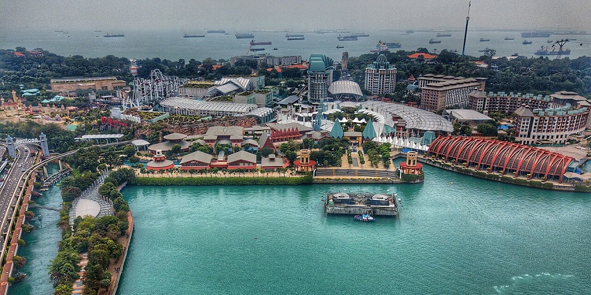 Aerial view of Sentosa Island in Singapore, showcasing beaches, resorts, and lush greenery
