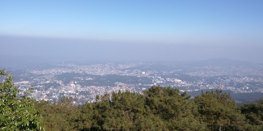Shillong city from Shillong Peak with green trees, buildings and houses of the city.