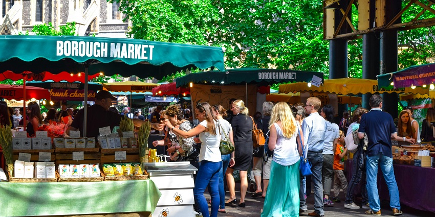 Shoppers browsing local produce at the bustling Nashville Farmers’ Market in summer.