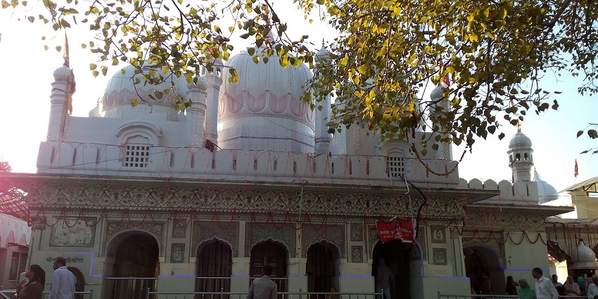 Shri Mata Mansa Devi Temple main shrine with detailed architecture, red flags, and visitors gathered in devotion at this sacred hilltop site.
