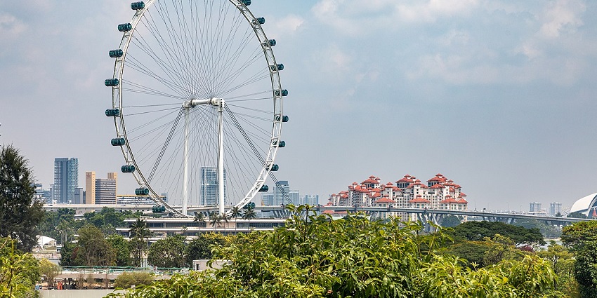 Singapore Flyer against a clear sky, highlighting its iconic Ferris wheel design, one of the best places to visit in Singapore in July.
