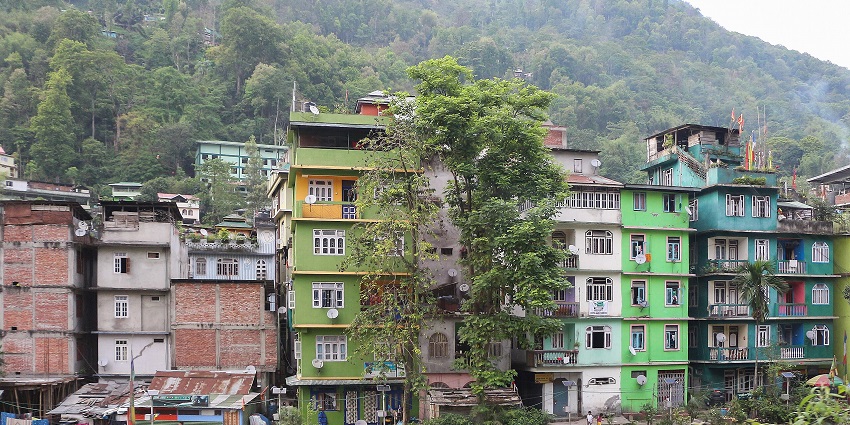 View of Singtam town with clustered buildings set against green hills in the background, one of the places to visit in Gangtok in June.