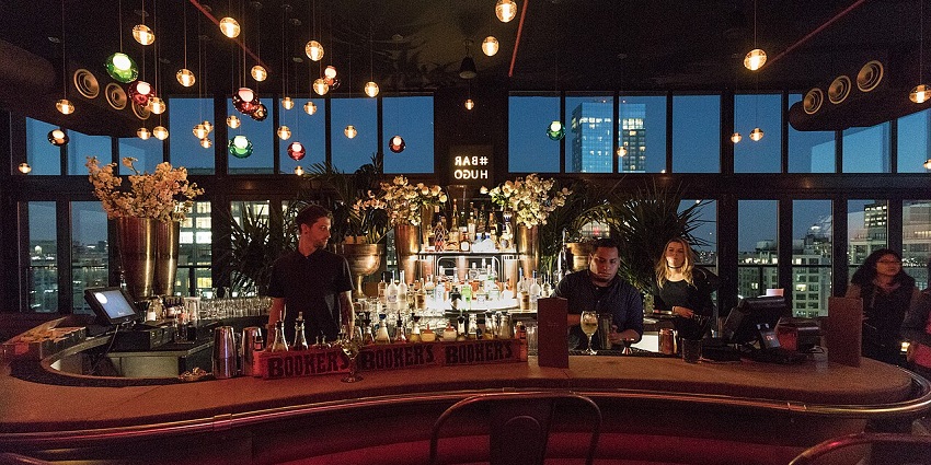 Cocktails and city skyline views from a trendy Miami rooftop bar.
