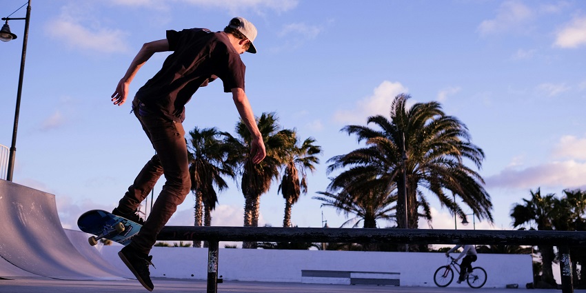 Skaters performing tricks at the shaded, concrete ramps of Golconda Skate Park in NY