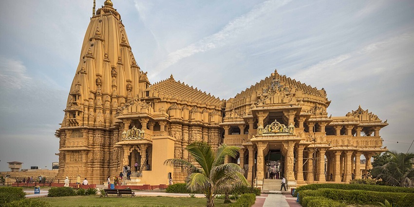 Majestic coastal temple of Lord Shiva with stone carvings and a scenic Arabian Sea backdrop.