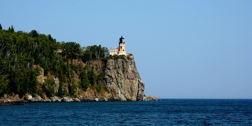 Split rock lighthouse at night with tall architecture, bright light, one of the historical places in Minnesota.