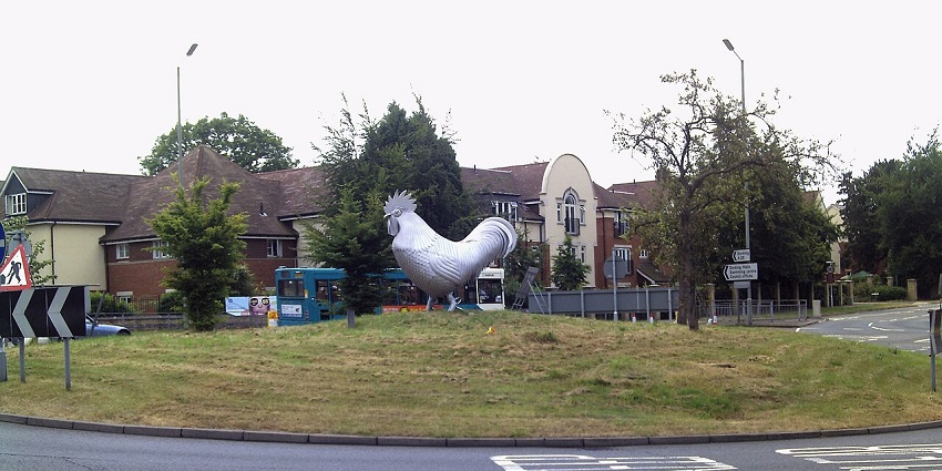 Large metal cockerel sculpture standing proudly in Dorking town.