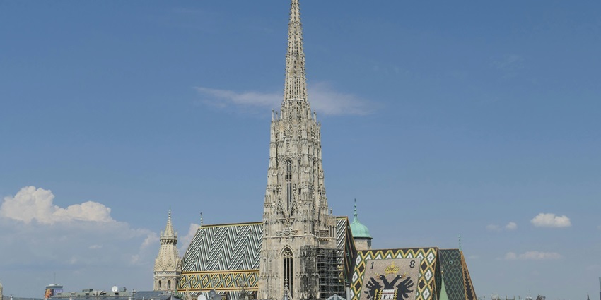 The exterior of St. Stephen’s Cathedral in Vienna, showing its detailed Gothic architecture, making it one of the most iconic historical places in Austria.