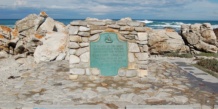 Pose at the geographical marker where the Indian and Atlantic Oceans meet in the day.