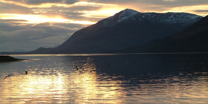 An image of a peaceful lakeside moment above the calm waters of the Loch Linnhe.
