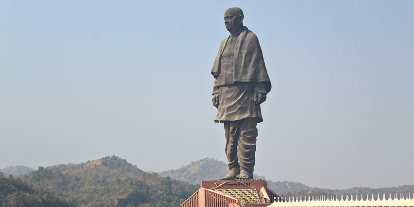 The World’s tallest statue of Sardar Patel stands grandly beside the Narmada River amid lush hills.