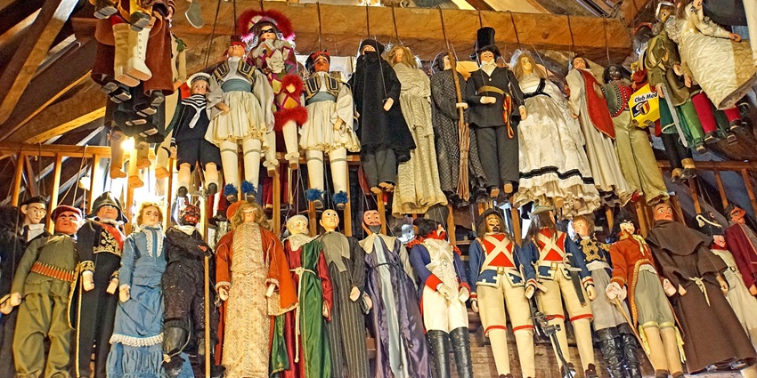 A puppet show theatre in the Marolles district with multiple unique puppets and a wooden roof