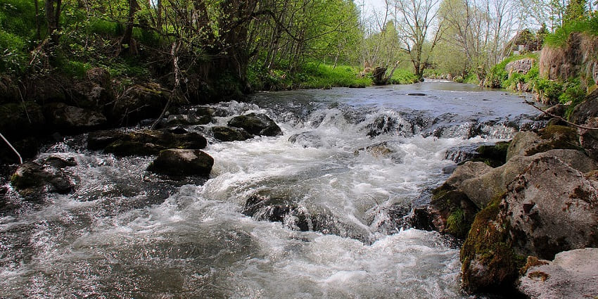 The Alb River flows through the charming town, bordered by stone walls and lively cafés.