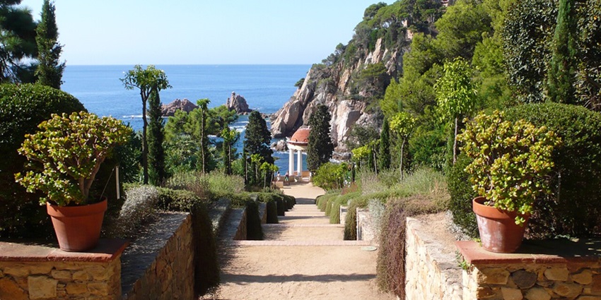 Visitors admiring exotic plants and Mediterranean sea views in the Marimurtra Botanical Gardens in Blanes.