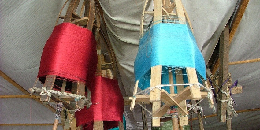 Traditional silk weaving in Sualkuchi Village with vibrant fabrics.