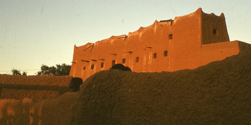 Monument in Agadez at a distance with its red sandy structure under the sunlight