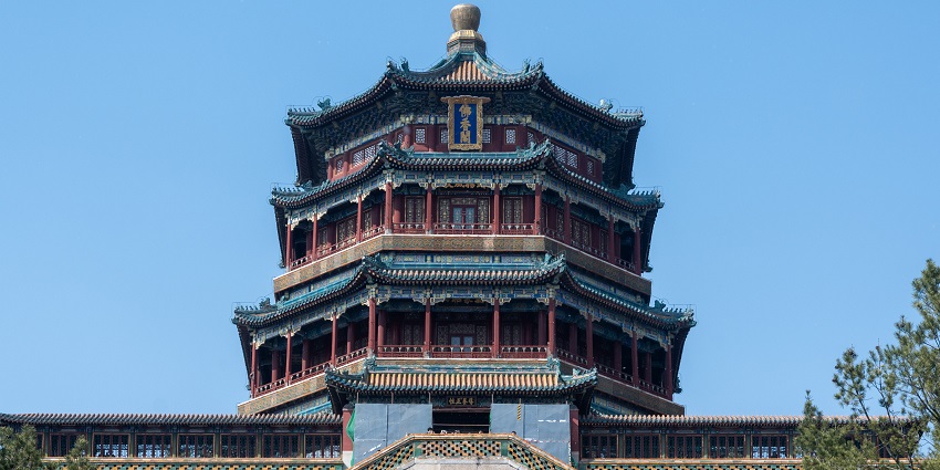 Facade of Summer Palace with detailed architecture, sculptures, signages and trees