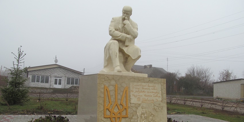 Taras Shevchenko monument in Ukraine, set in a central park near administrative buildings.