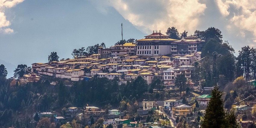 Tawang monastery from a distance, with old traditional architectural buildings and trees