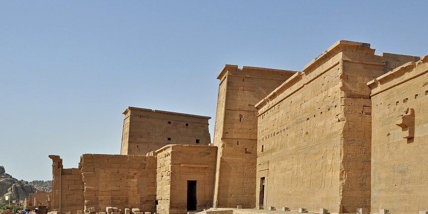 The Ancient Temple of Philae in Aswan, showing stone walls and hieroglyphic carvings, one of the historical places in Egypt.