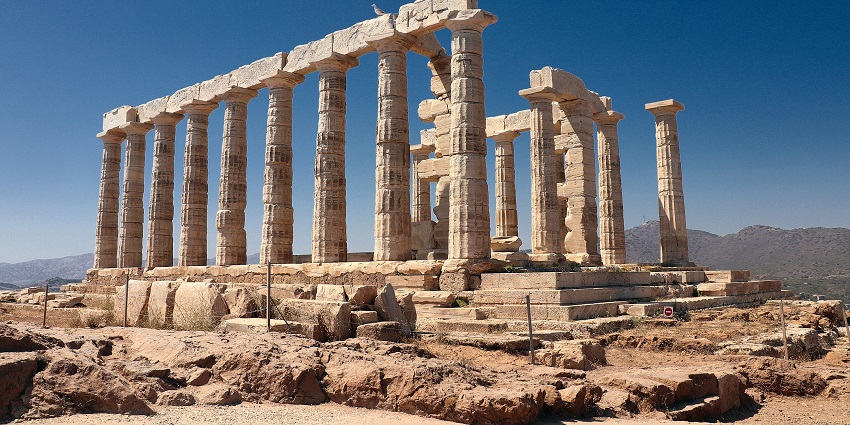 The Temple of Poseidon, a famous monument in Greece, features towering Doric columns.