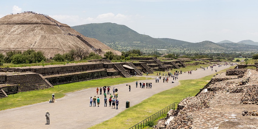 Teotihuacan with ruins, people walking on the road, sets of stairs, one of the famous historical places in Mexico.