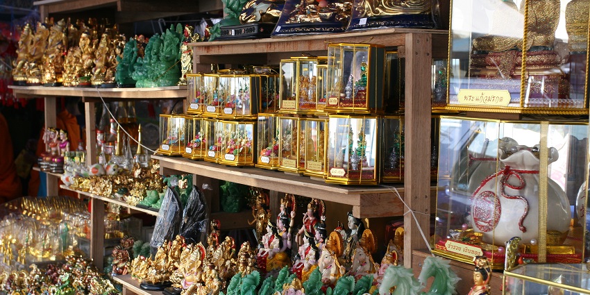 The phra chan amulet market with small figurines of Hindu and Buddha gods in the shop.