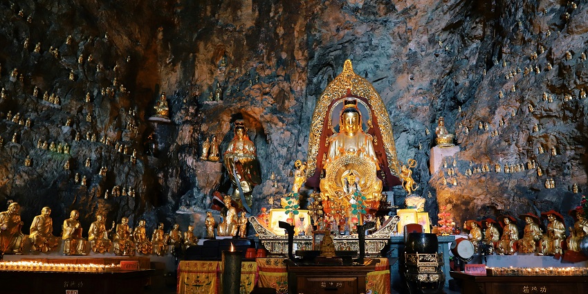 Inside Tham Khao Luang cave, with unique rock formations and multiple Buddha statues, one of the top places to visit in Thailand in March.