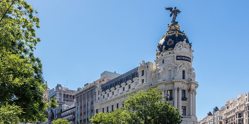 The Metropolis Building stands majestically at the corner. What is Madrid famous for?.