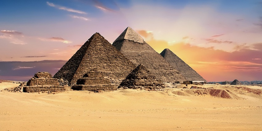 An image of the Great Pyramid of Giza under a partly cloudy sky, one of the top historical places in Egypt.