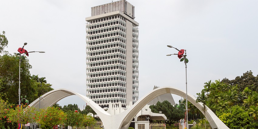 A tall building with stunning architecture is situated in the middle of the city of Kuala Lumpur.