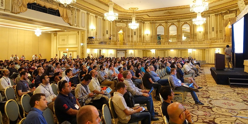 Interior of Palmer house with crowd of people sitting in the ballroom and unique lighting.