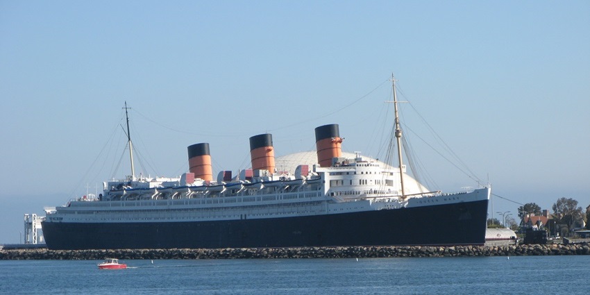 The Queen Mary ship docked at a port, one of the most iconic historical places in Los Angeles.