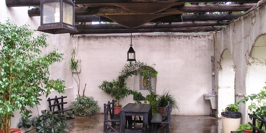 Interior of the Spanish governor’s palace with table, chairs, multiple plants in the plant pots