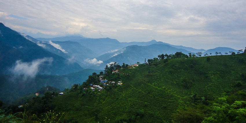 Tiger Hill with lush green mountains and clouds, one of the best places to visit Darjeeling in June.
