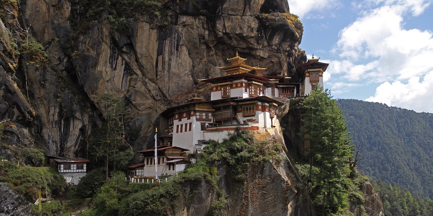 Paro Taktsang, dramatically perched on a cliffside, is one of the most iconic monuments in Bhutan, surrounded by lush forest.