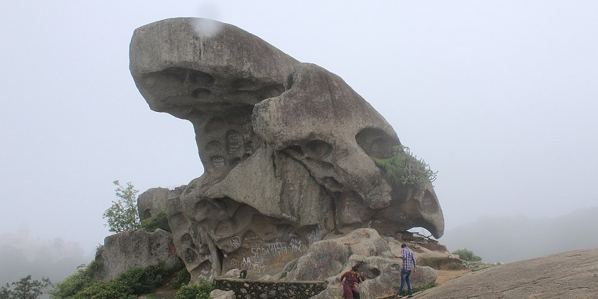 Toad rock at Mount Abu with a big toad-shaped rock, writings on the rock and people.