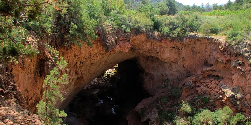 Tonto Natural Bridge State Park with a small trail of water flowing under the natural bridge